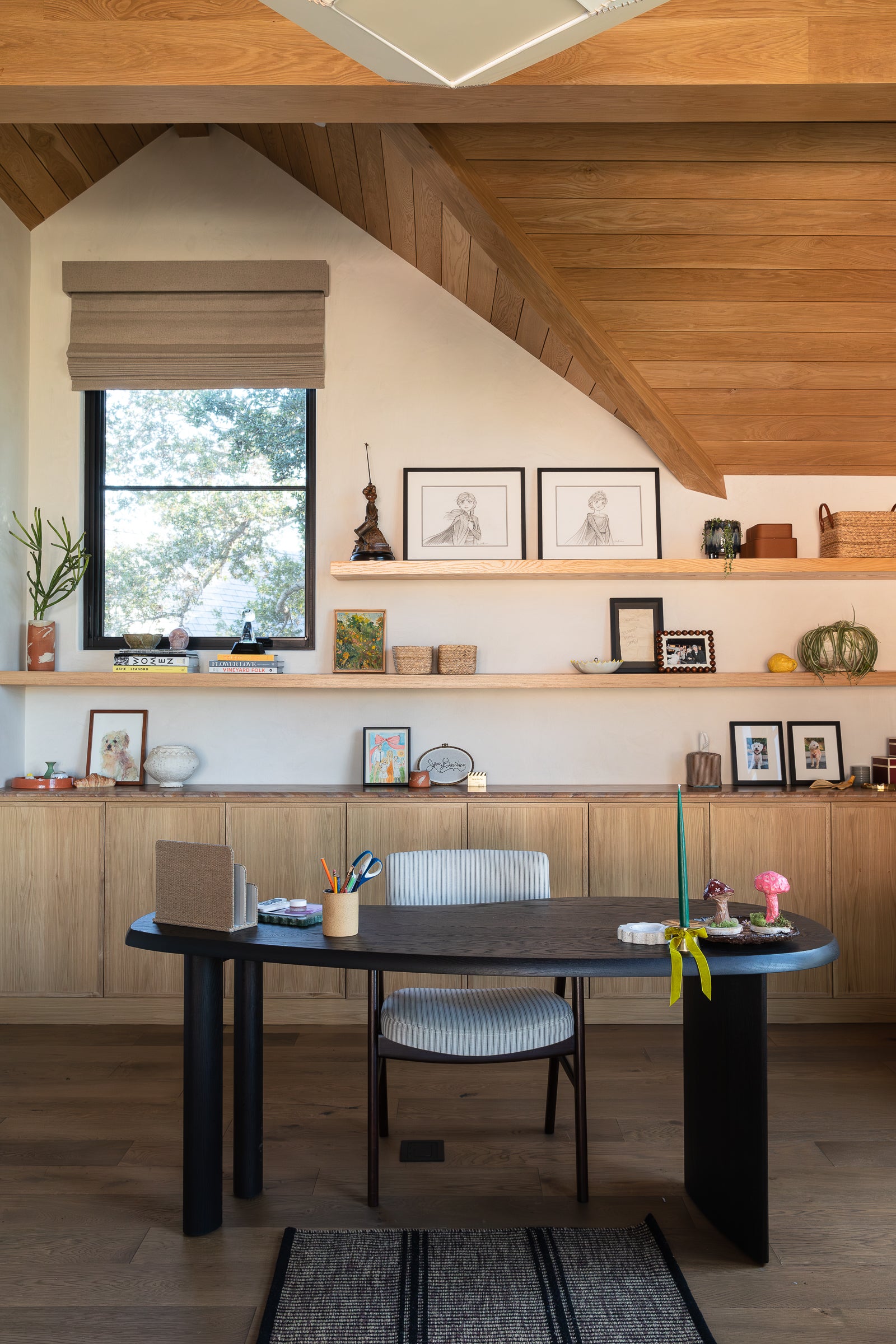 Kristen Bell office design by EARL Home. Custom white oak cabinet built-in with floating shelves.