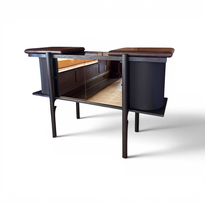 Dark wood record cabinet with brown leather top on a white background
