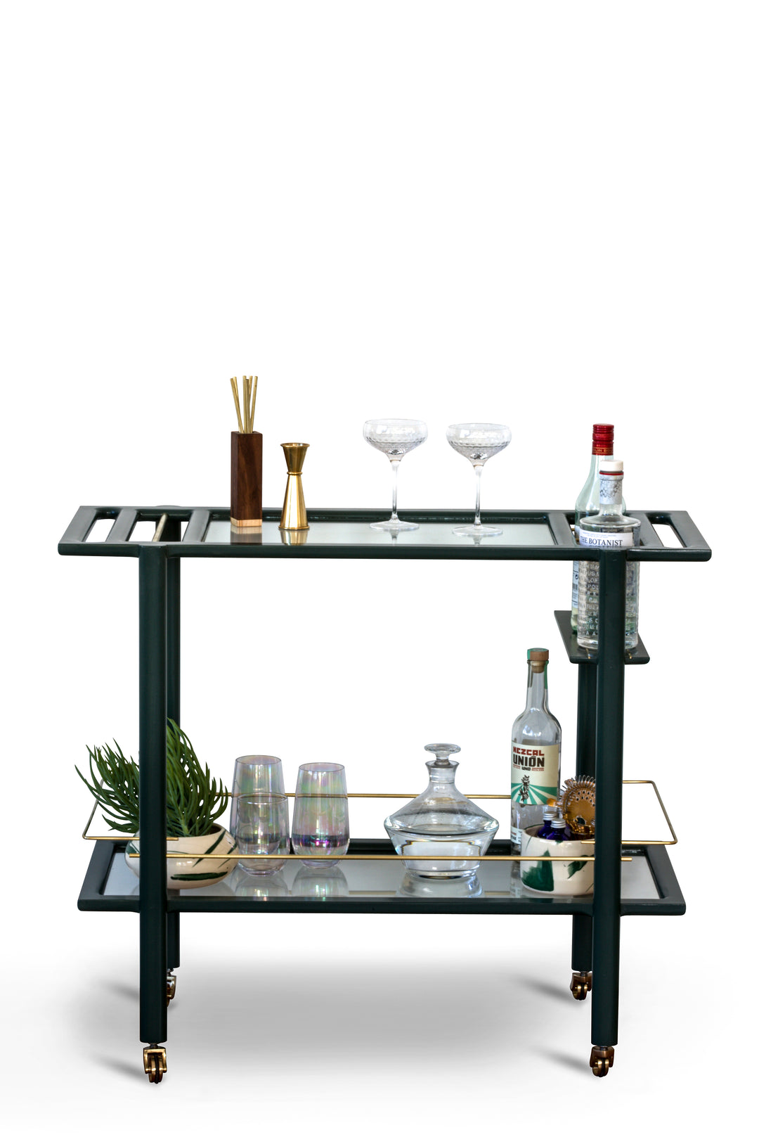 The BAR Cart from Earl Home is a solid wood bar cart on wheels with exquisite hand-cut joinery, featuring two shelves: a robust wood top and an elegant lower shelf made of tempered glass panels.