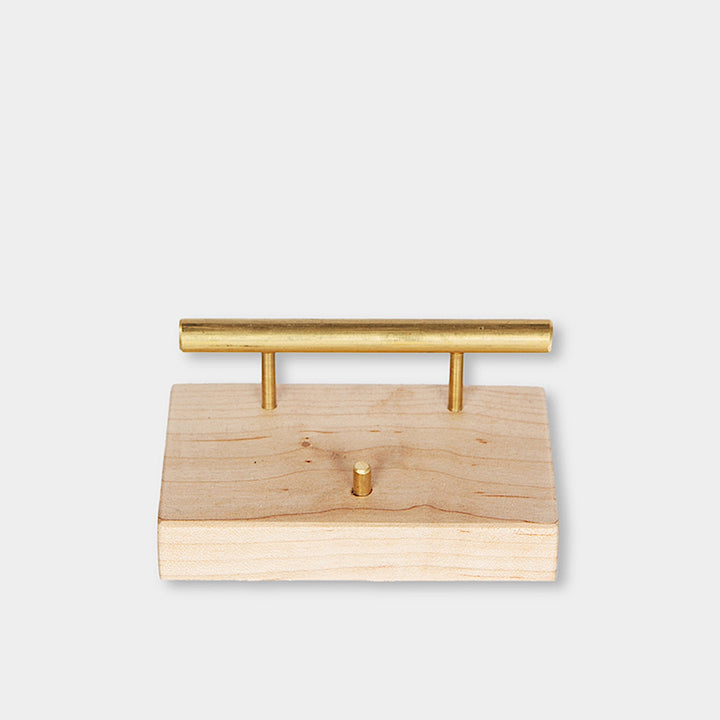 The BUSINESS Card Holder, expertly crafted by Earl Home from wood and brass, showcases a card with "CHRIS EARL." This elegant accessory can be customized to perfectly fit any desk or office setting.