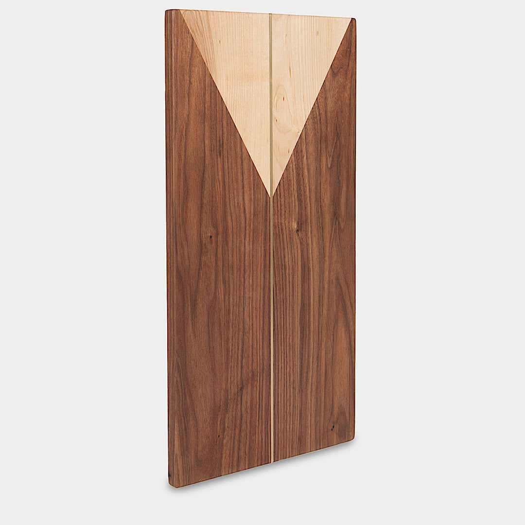 The RECTANGLE Cheese Board by Earl Home is a handcrafted serving board featuring a natural wood grain and accented with an off-center pale triangle on the left, ideal for elegant entertaining.