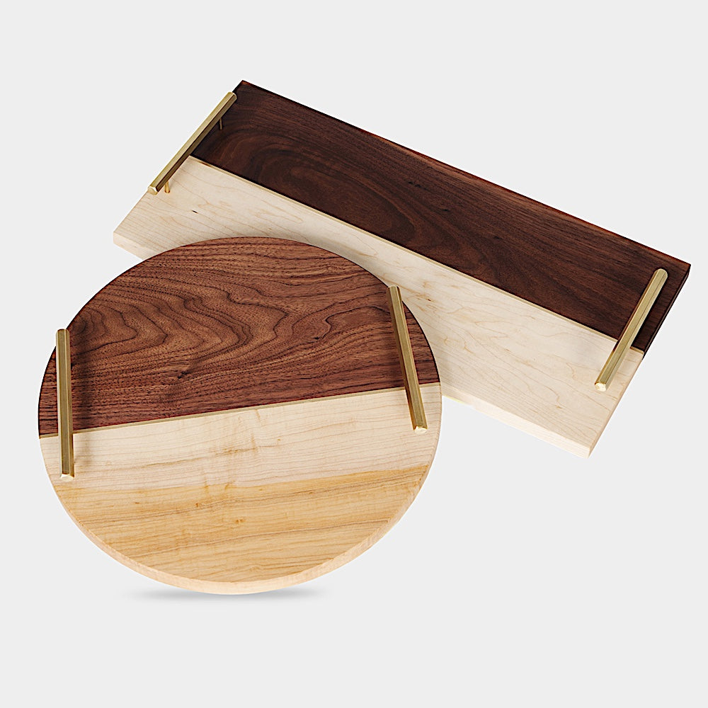 The RECTANGLE Service Tray by Earl Home is a handcrafted, two-tone wooden serving board with elegant brass handles, featuring a light and dark wood design akin to a classic brass tray.