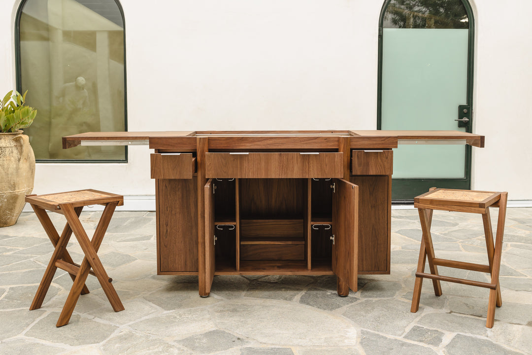 The LAPILO Folding Stool by Earl Home features a square solid wood top and cross-legged design in a sleek white finish.