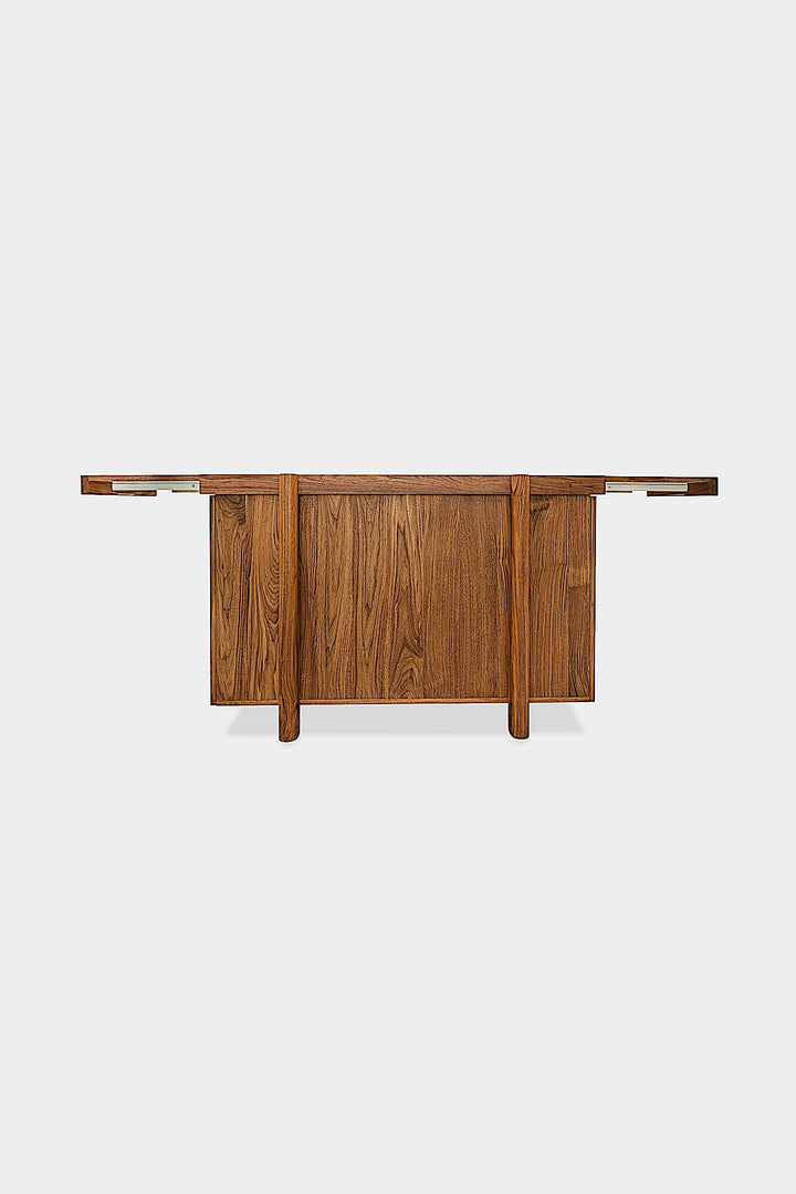 Handmade to order, the LAPILO Bar by Earl Home features open doors and drawers that reveal storage compartments and shelves, making it an ideal choice for a stylish and functional dry bar setup.