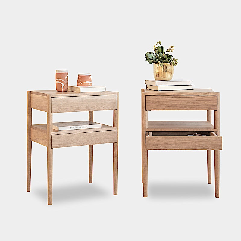 The Earl Home BEDSIDE Table is a solid wood nightstand featuring two open drawers, a minimalist design, and a natural finish. Custom sizing ensures it fits your space perfectly.