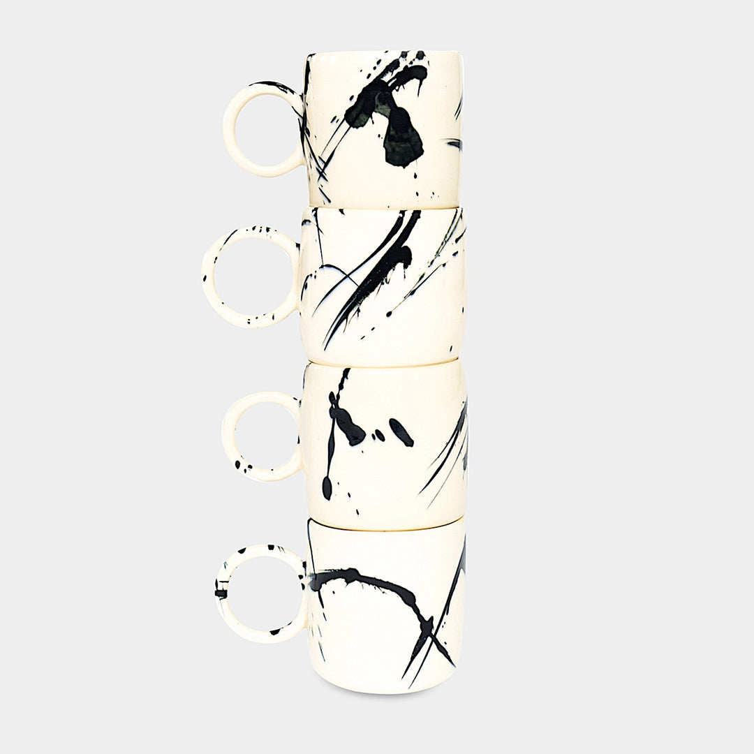 Earl Home's CIRCLE Mug is a hand-thrown white ceramic mug with black brush stroke splatters and a round handle.