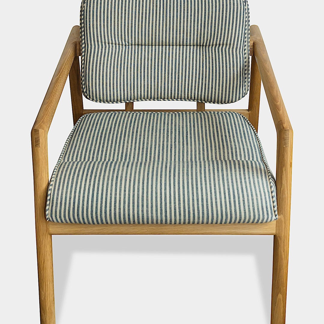 Side view of the Earl Home White Oak MORESBY Lounge Chair with blue and gray Perennials Tatton Stripe cushions, set against a plain background.