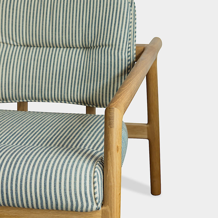 Side view of the Earl Home White Oak MORESBY Lounge Chair with blue and gray Perennials Tatton Stripe cushions, set against a plain background.