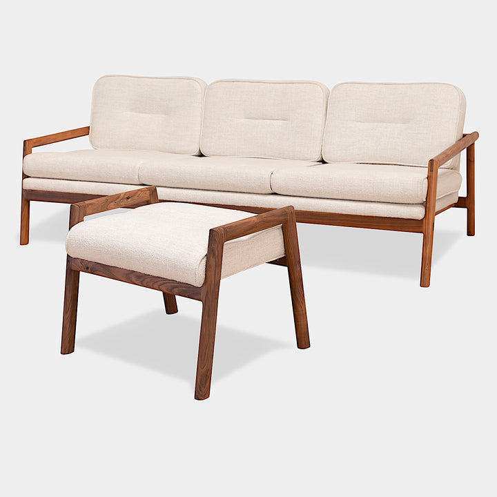 The MORESBY Ottoman by Earl Home is a handmade, custom order wooden stool with a light beige upholstered seat on four legs, set against a plain white background.