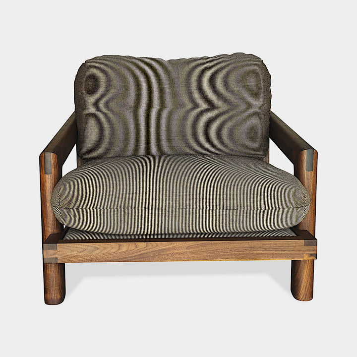 The Earl Home Walnut TAMBU Lounge Chair boasts olive leather upholstery, a sturdy walnut frame, and cushioned seat and backrest.