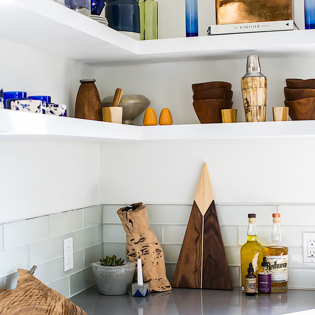 The TRIANGLE Cheese Board by Earl Home is a stylish centerpiece with a triangular design. It is solid walnut and maple featuring a brass spline. Perfect for your cheeseboard or charcuterie spread.