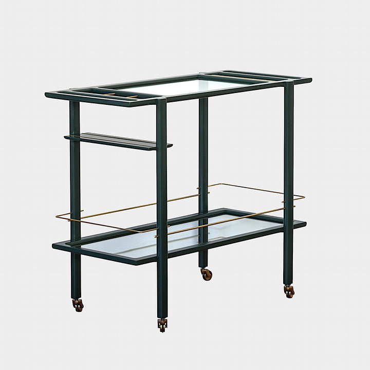 The Earl Home bar cart in deep green and copper showcases tempered glass panels and striking copper accents, complete with four wheels for easy movement.