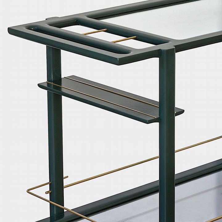 The Earl Home bar cart in deep green and copper showcases tempered glass panels and striking copper accents, complete with four wheels for easy movement.