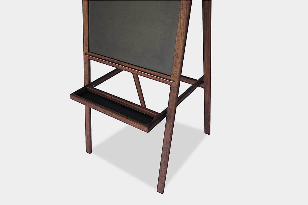 The KIDS Easel by Earl Home is a freestanding kids' easel made from sustainably sourced hardwood, featuring a chalkboard surface and a paper roll at the top.