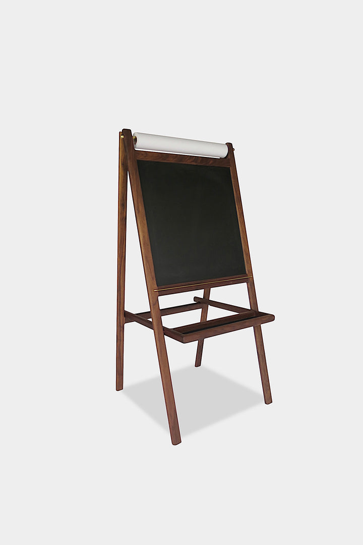 The KIDS Easel by Earl Home is a freestanding kids' easel made from sustainably sourced hardwood, featuring a chalkboard surface and a paper roll at the top.