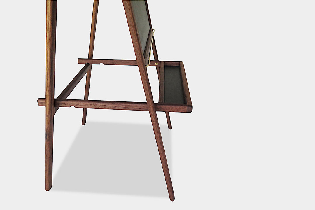 The KIDS Easel by Earl Home is a freestanding kids' easel made from sustainably sourced hardwood, featuring a chalkboard surface and a paper roll at the top.