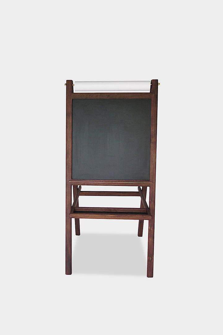 The KIDS Easel by Earl Home is a freestanding kids' easel made from sustainably sourced hardwood, featuring a chalkboard surface and a paper roll at the top.