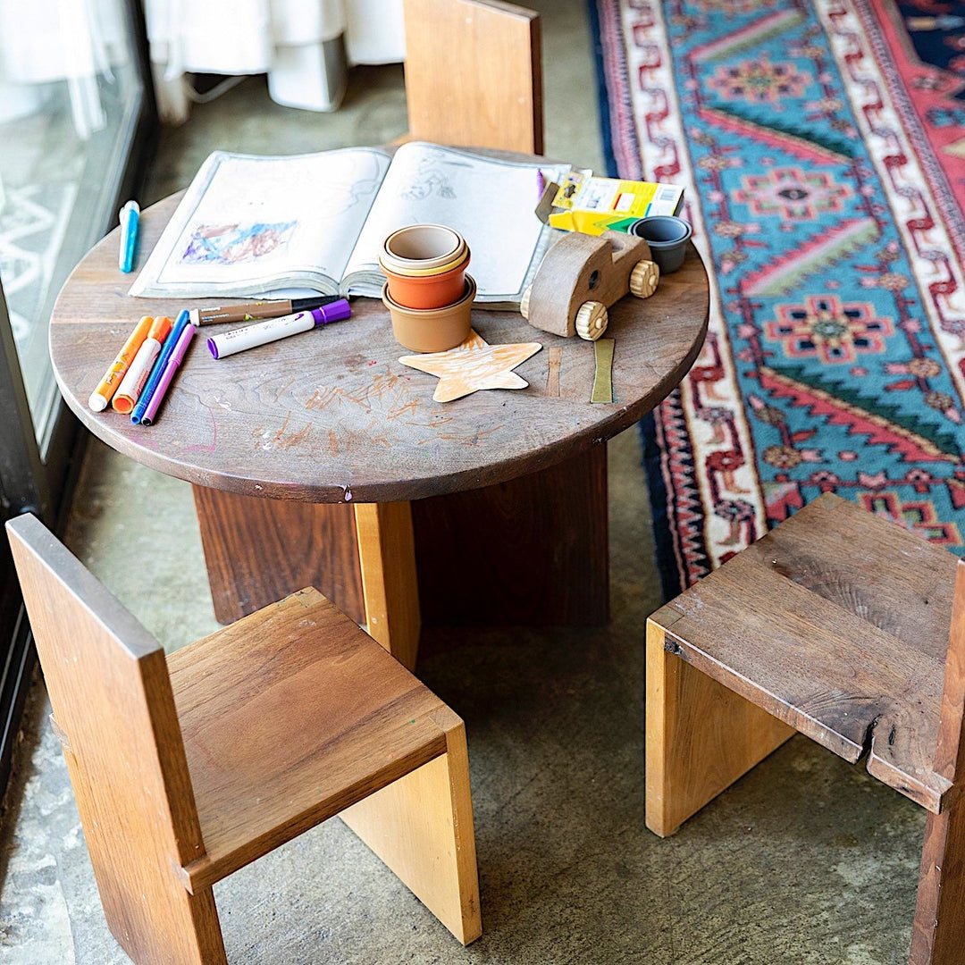 A top view showcases the Earl Home KIDS Set, featuring a custom, round wooden table made from sustainably sourced American hardwood. Two rectangular chairs are ideally positioned on opposite sides for a kid's table setup.