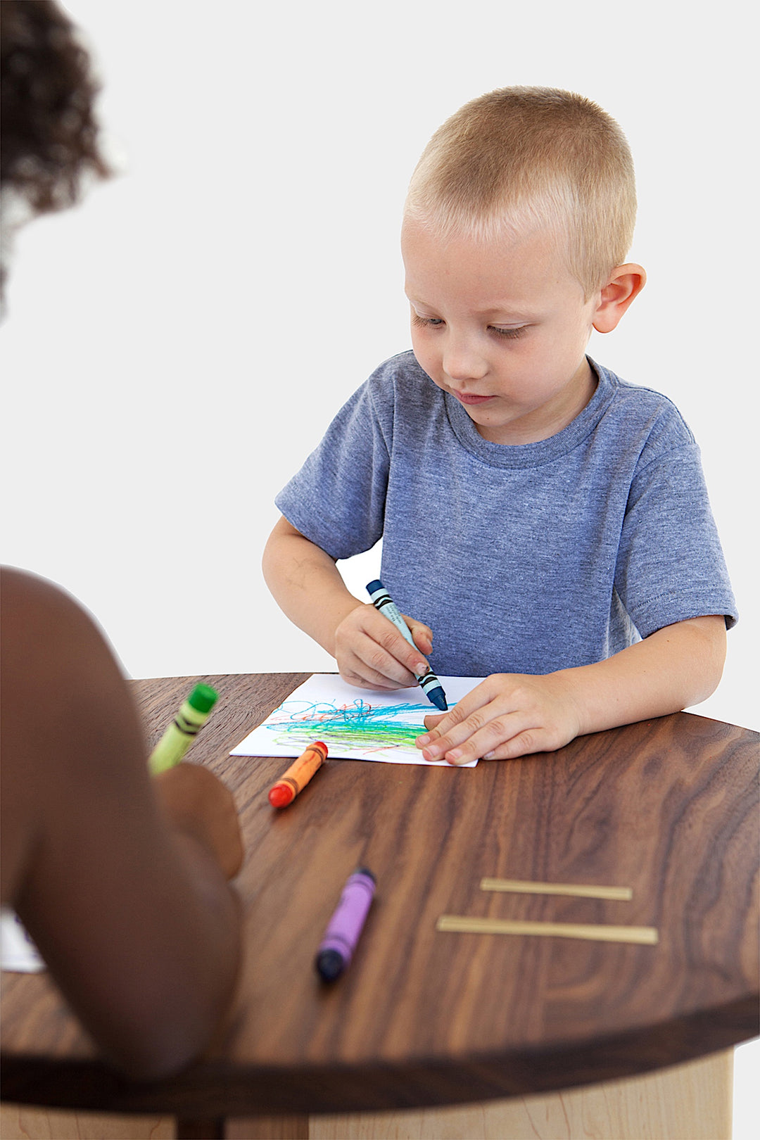 A top view showcases the Earl Home KIDS Set, featuring a custom, round wooden table made from sustainably sourced American hardwood. Two rectangular chairs are ideally positioned on opposite sides for a kid's table setup.