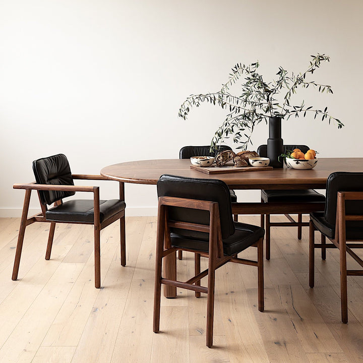 The MORESBY Captain Chair by Earl Home is hand-made with a custom upholstered seat in rich brown leather and solid wood, set against a white background.