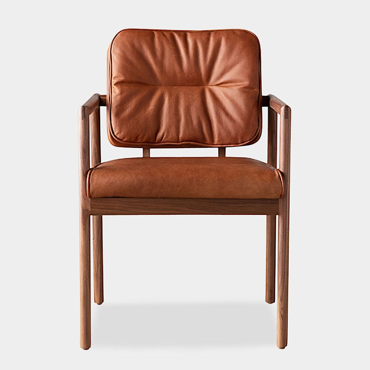 The MORESBY Captain Chair by Earl Home is hand-made with a custom upholstered seat in rich brown leather and solid wood, set against a white background.