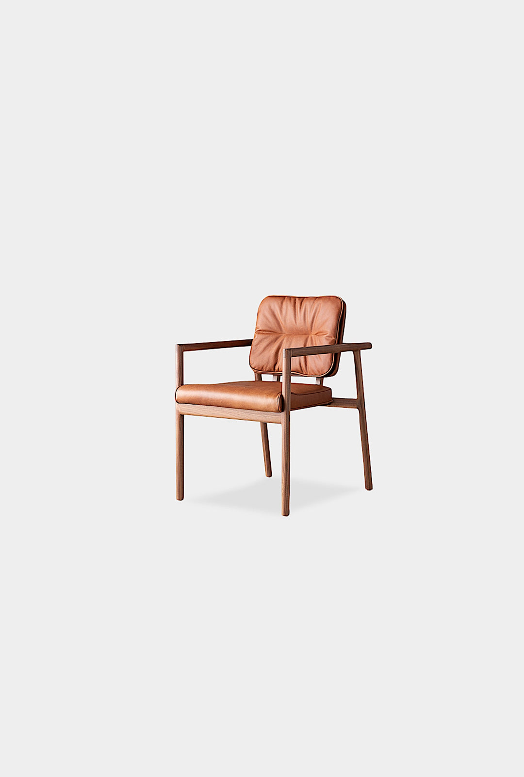 The MORESBY Captain Chair by Earl Home is hand-made with a custom upholstered seat in rich brown leather and solid wood, set against a white background.