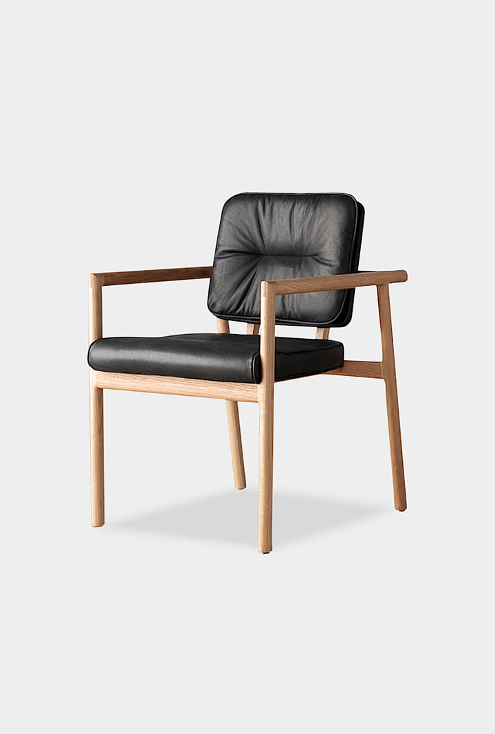 The MORESBY Captain Chair by Earl Home is hand-made with a custom upholstered seat in rich brown leather and solid wood, set against a white background.