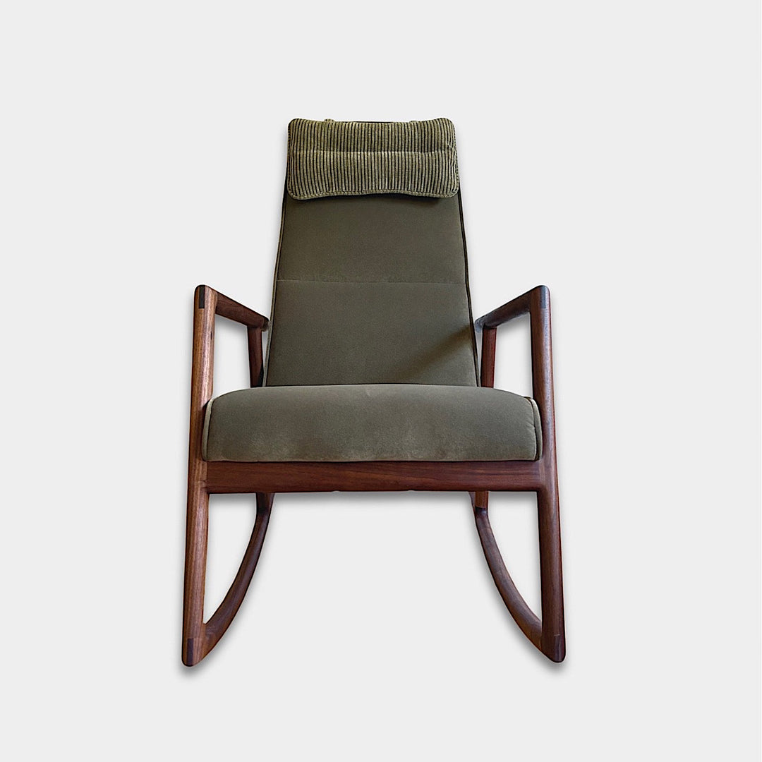 Side view of the Walnut MORESBY Rocker by Earl Home, featuring a green upholstered seat with a cushion, solid wood frame, and armrests against a white background.