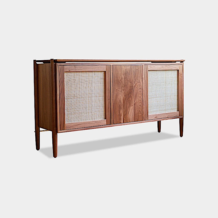 The KABOT Sideboard (Low) by Earl Home is a wooden mid-century modern dresser, featuring two woven panels and slender legs, exemplifying heritage quality design.