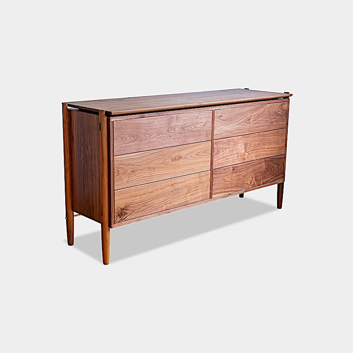 The KABOT Sideboard (Low) by Earl Home is a wooden mid-century modern dresser, featuring two woven panels and slender legs, exemplifying heritage quality design.