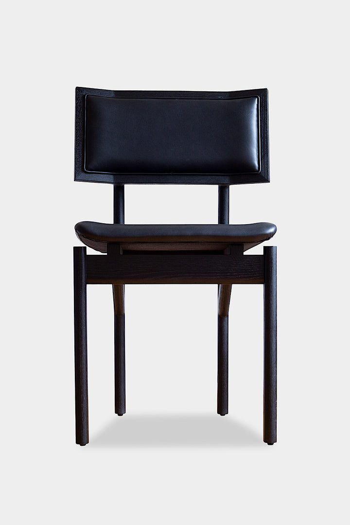 The KUNAI Dining Chair by Earl Home is handcrafted to order, featuring a solid wood frame, brown leather seat, and woven backrest.