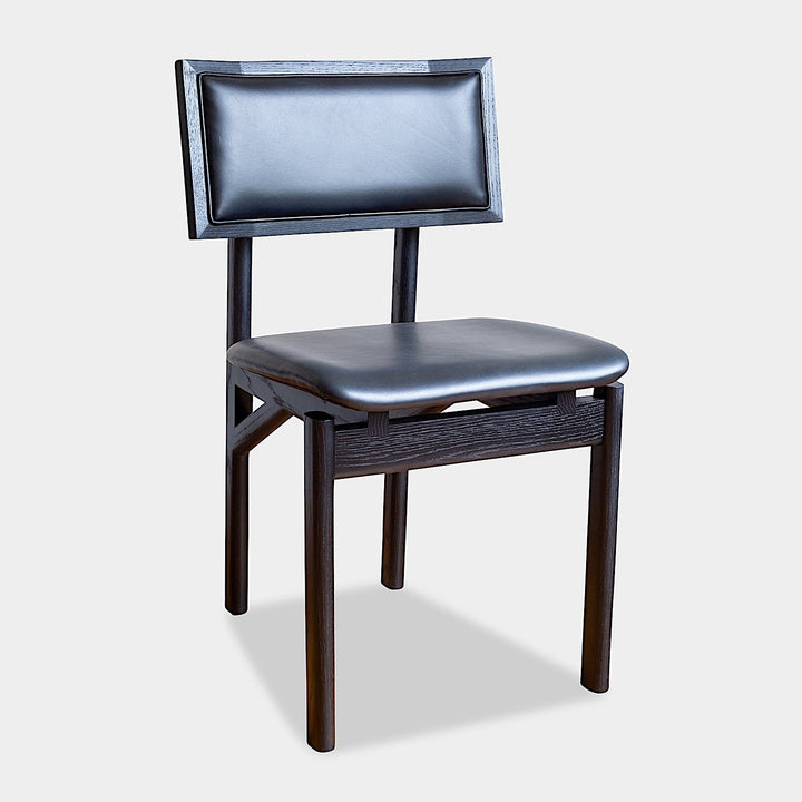 The KUNAI Dining Chair by Earl Home is handcrafted to order, featuring a solid wood frame, brown leather seat, and woven backrest.