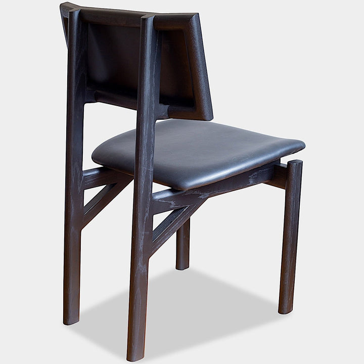 The KUNAI Dining Chair by Earl Home is handcrafted to order, featuring a solid wood frame, brown leather seat, and woven backrest.