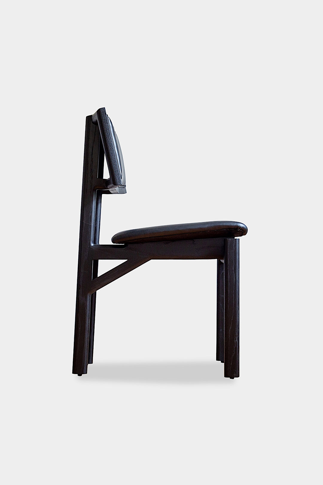 The KUNAI Dining Chair by Earl Home is handcrafted to order, featuring a solid wood frame, brown leather seat, and woven backrest.