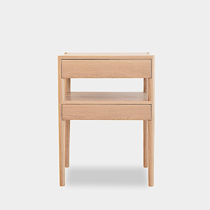 The Earl Home BEDSIDE Table is a solid wood nightstand featuring two open drawers, a minimalist design, and a natural finish. Custom sizing ensures it fits your space perfectly.