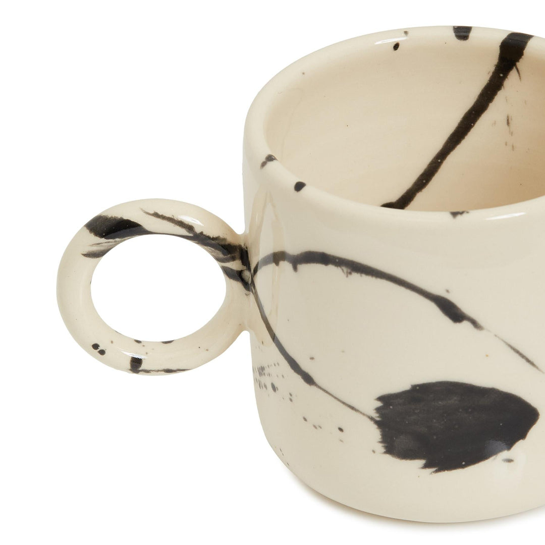 black splattered cylindrical mug hand thrown and made in los angeles.