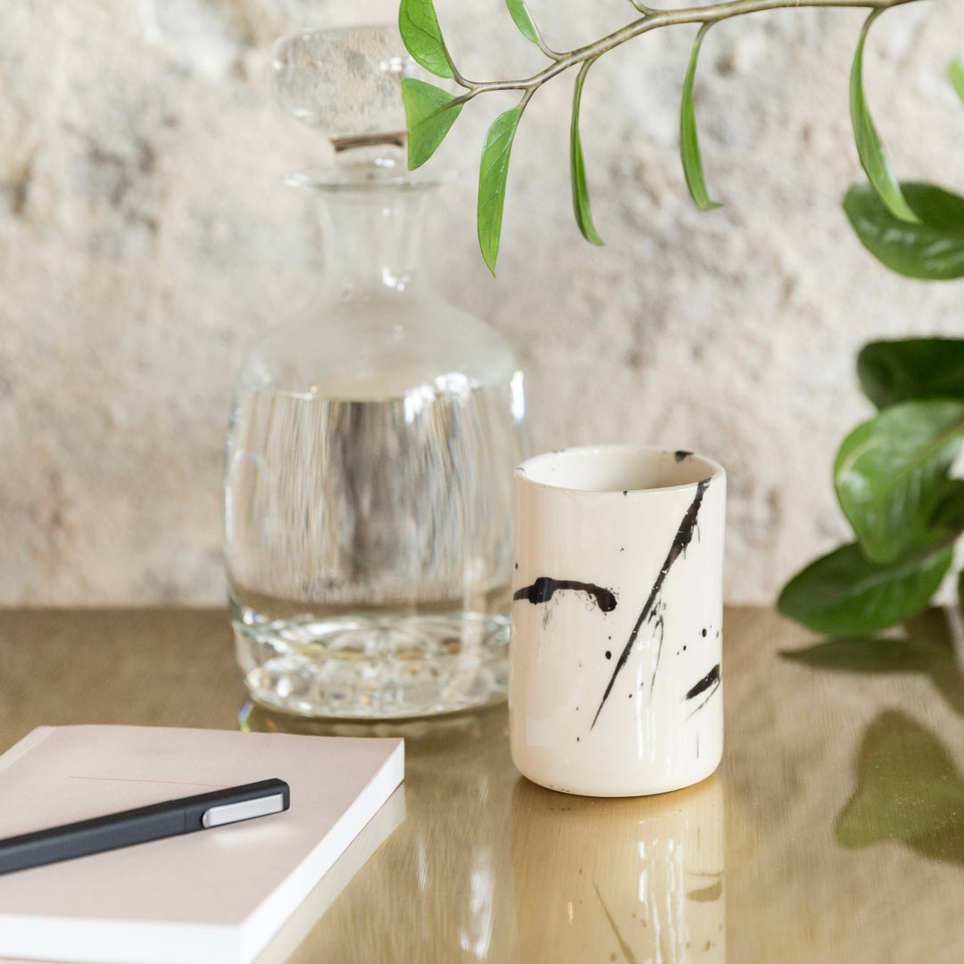 Four cylindrical cups with blue splatter abstract paint or glaze design. Hand thrown handmade pottery. Coffee Cup or mug perfect for cozy hygge morning. 