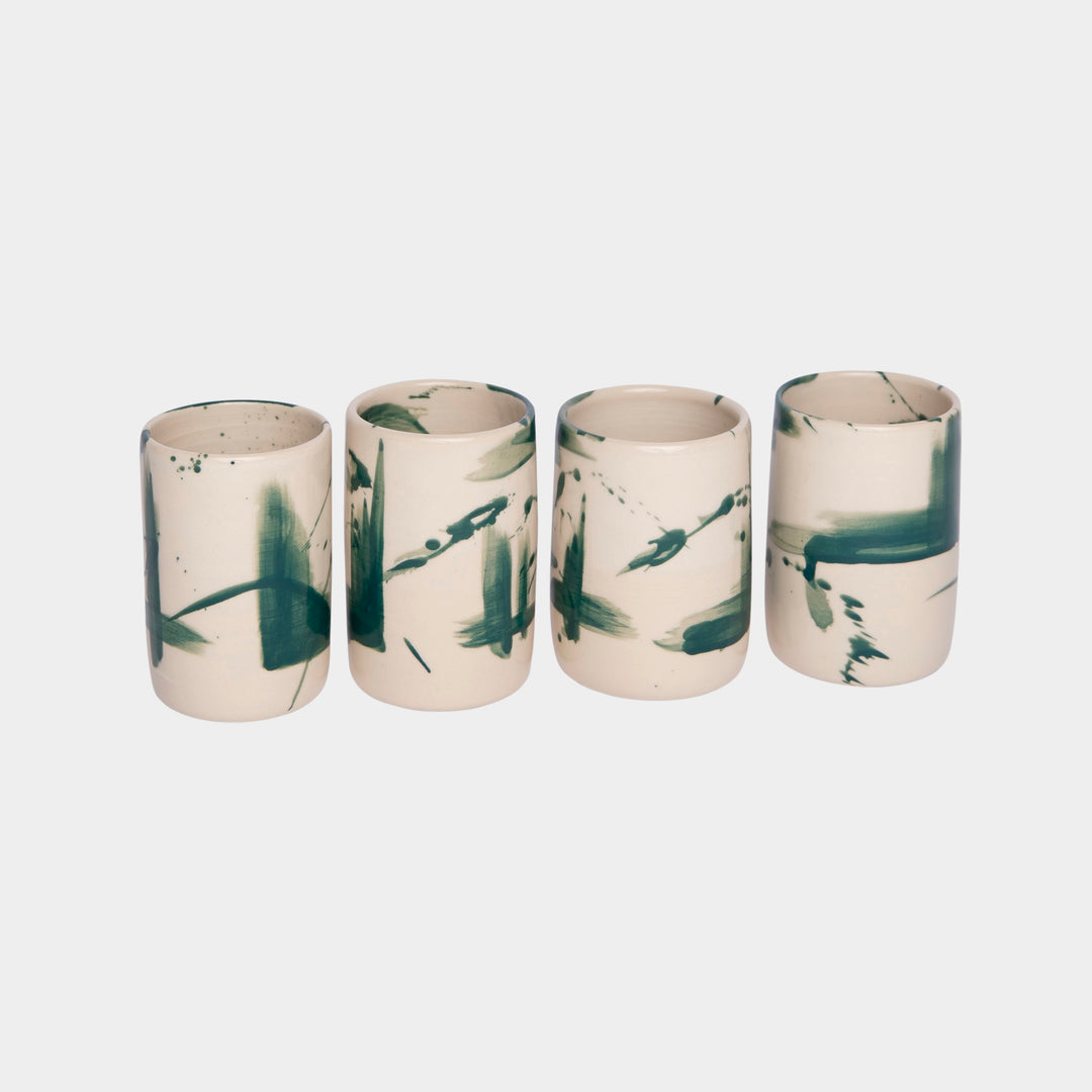 Four cylindrical cups with green splatter abstract paint or glaze design. Hand thrown handmade pottery. Coffee Cup or mug perfect for cozy hygge morning. 