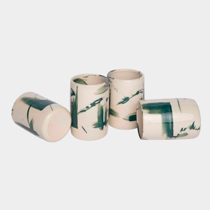 Four cylindrical cups with blue splatter abstract paint or glaze design. Hand thrown handmade pottery. Coffee Cup or mug perfect for cozy hygge morning. 
