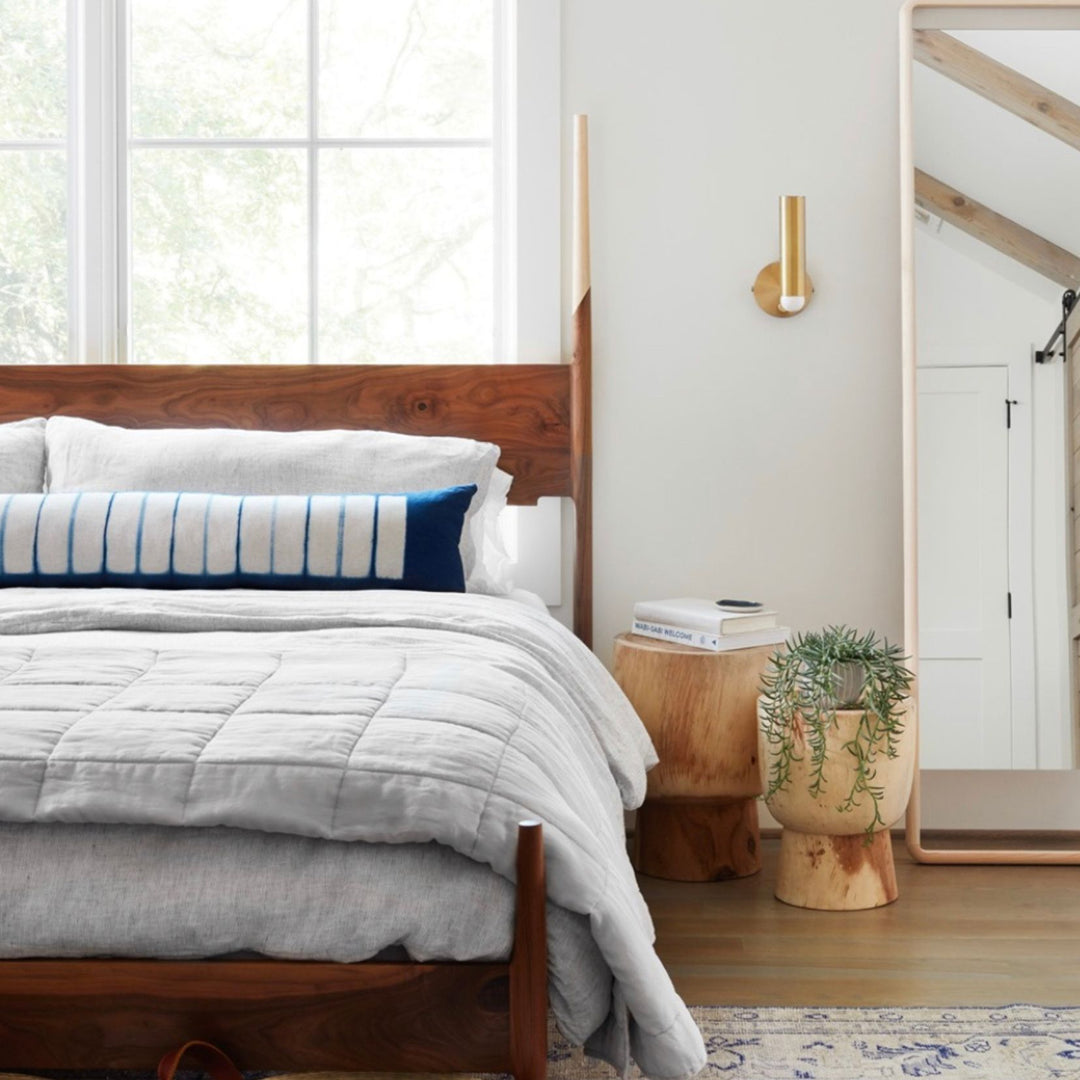 The DANSK Bed by Earl Home features a solid wood frame with a tall headboard and luxurious bedding, creating your perfect sanctuary. Crafted in walnut with maple spliced posts it exemplifies quality and is handmade to order. It is available in White oak, ebonized oak or ash. The dutchman joint can be hand cut in tonal wood, brass, copper, or aluminum.