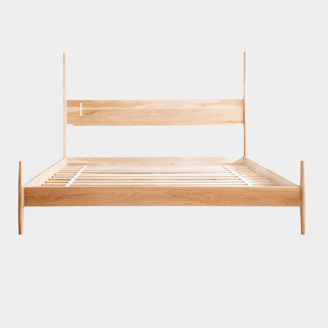 The DANSK Bed by Earl Home features a solid wood frame with a tall headboard and luxurious bedding, creating your perfect sanctuary. Originally crafted in Los Angeles, California in walnut with maple spliced posts it exemplifies quality and is handmade to order. It is available in White oak, ebonized oak or ash. The dutchman joint can be hand cut in tonal wood, brass, copper, or aluminum.