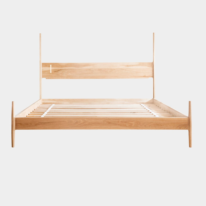 The DANSK Bed by Earl Home features a solid wood frame with a tall headboard and luxurious bedding, creating your perfect sanctuary. Originally crafted in Los Angeles, California in walnut with maple spliced posts it exemplifies quality and is handmade to order. It is available in White oak, ebonized oak or ash. The dutchman joint can be hand cut in tonal wood, brass, copper, or aluminum.