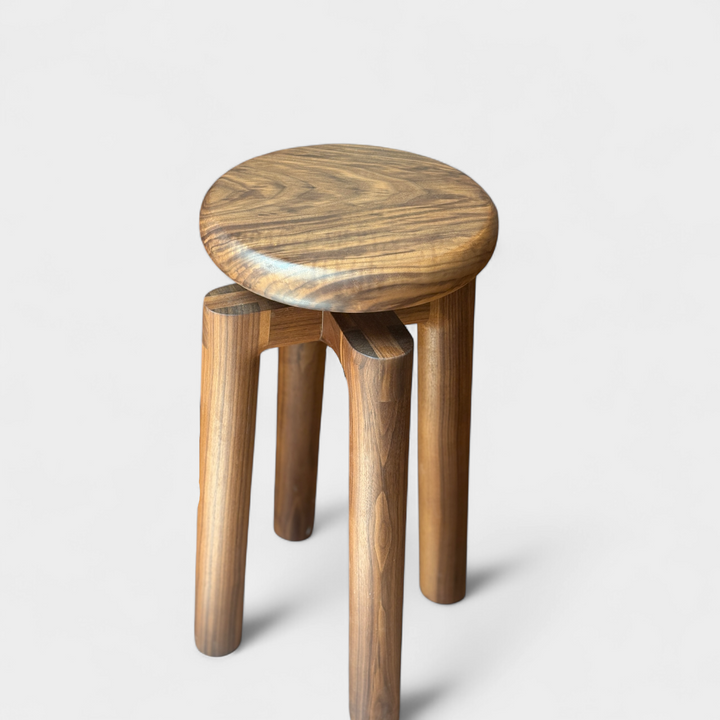 Solid walnut wood stool with a round seat that swivel screws up and down 5". Available in white oak, ebonized oak, white oak, and ash.