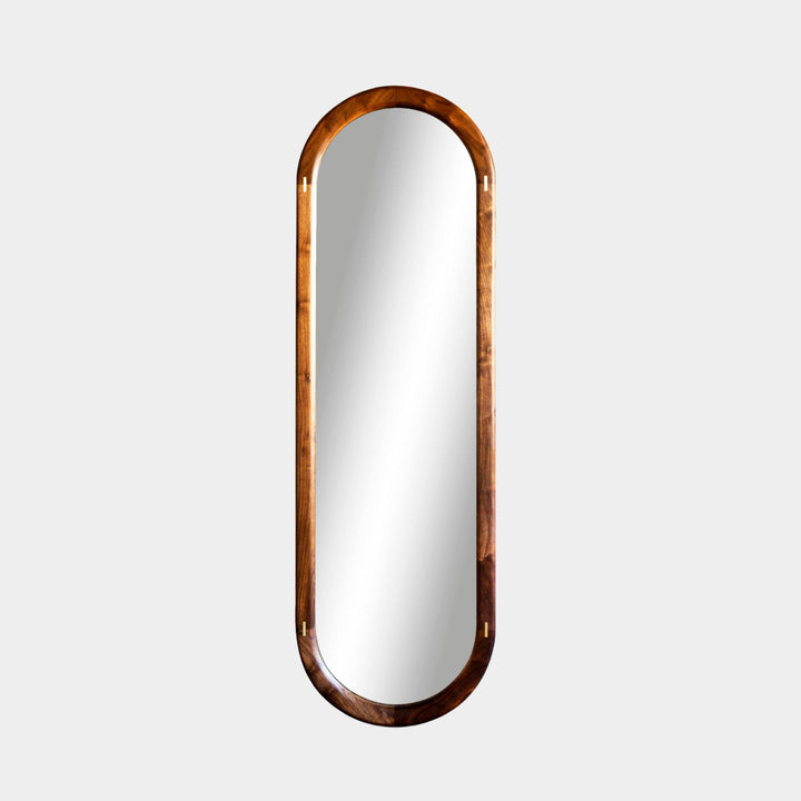The HAROLD Mirror by Earl Home, a rectangular solid wood piece with metal inlay detailing, exquisitely reflects window light to enhance room brightness.