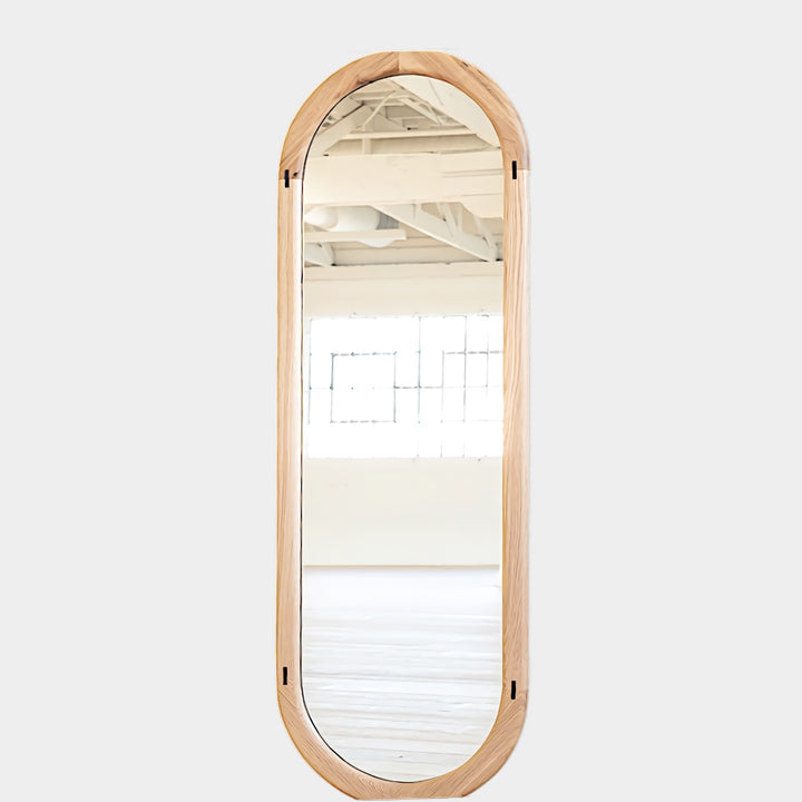 The HAROLD Mirror by Earl Home, a rectangular solid wood piece with metal inlay detailing, exquisitely reflects window light to enhance room brightness.