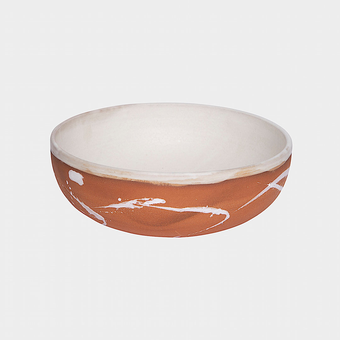 The Earl Home SERVING Bowl is a hand-thrown ceramic piece featuring a white interior and terracotta exterior with elegant swirl patterns. It is dishwasher and microwave safe.