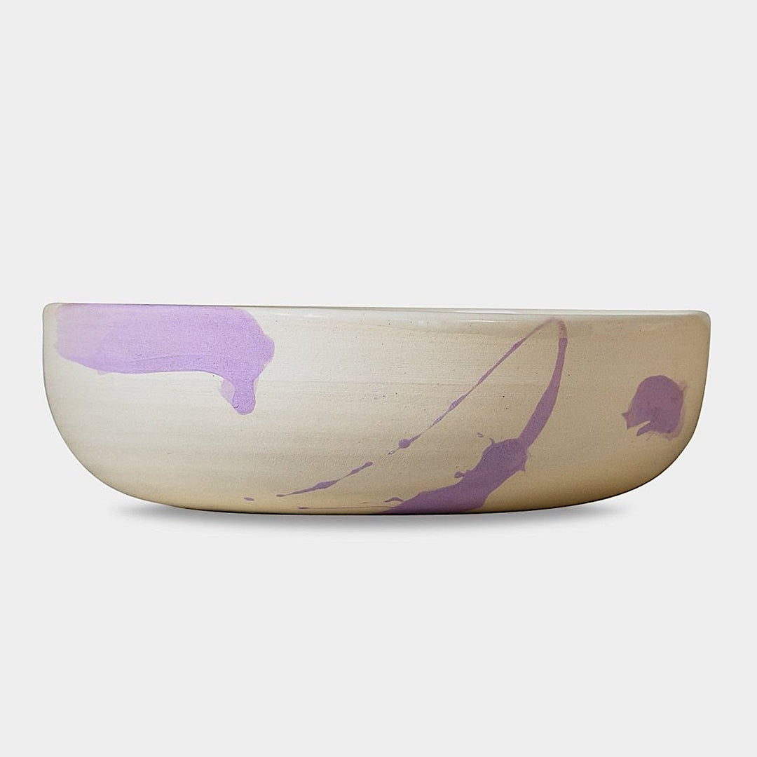 The Earl Home SERVING Bowl is a hand-thrown ceramic piece featuring a white interior and terracotta exterior with elegant swirl patterns. It is dishwasher and microwave safe.