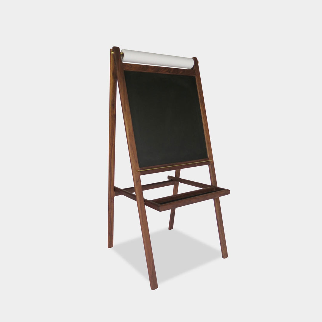 The KIDS Easel by Earl Home is a freestanding kids' easel made from sustainably sourced hardwood, featuring a chalkboard surface and a paper roll at the top. Available in ebonized oak, walnut or white oak.