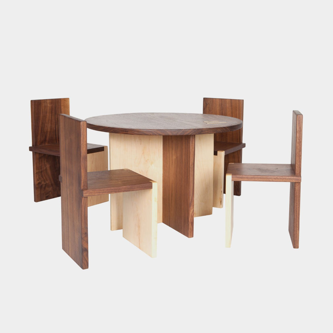 The Earl Home KIDS Set, featuring a custom, round wooden table made from sustainably sourced American hardwood. Two rectangular chairs are ideally positioned on opposite sides for a kid's table setup. Walnut mixed with maple, solid walnut, solid white oak, ebonized oak are all options for this custom made to order set.