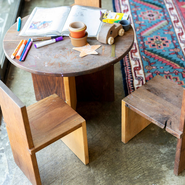 The Earl Home KIDS Set, featuring a custom, round wooden table made from sustainably sourced American hardwood. Two rectangular chairs are ideally positioned on opposite sides for a kid's table setup. Walnut mixed with maple, solid walnut, solid white oak, ebonized oak are all options for this custom made to order set.